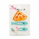 Three whimsical hair clips on cream card.webp