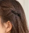 Black wavy barrette in brown hair-2.webp