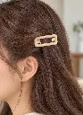 Glossy beige snap clip in brown hair-2.webp