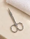 Silver eyebrow scissors on cream vanity-2.webp