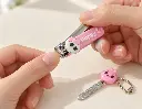 Pink skull nail clipper in use-2.webp